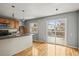 Well-lit kitchen featuring wood cabinets, an island sink, and sliding doors to the deck at 16325 E Alabama Dr, Aurora, CO 80017