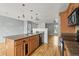 Open kitchen featuring wood cabinets, tile floors, a kitchen island and views to the living room at 16325 E Alabama Dr, Aurora, CO 80017
