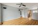 An open concept living room offers a ceiling fan and hardwood floors at 16325 E Alabama Dr, Aurora, CO 80017