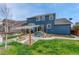 Backyard patio with shade, ideal for outdoor entertaining and dining on a well manicured lawn at 3367 Dove Valley Pl, Castle Rock, CO 80108