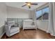 Cozy bedroom with chair, crib and large window at 3367 Dove Valley Pl, Castle Rock, CO 80108
