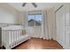 Bright bedroom features a crib and closet at 3367 Dove Valley Pl, Castle Rock, CO 80108