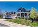Charming two-story home with blue siding, stone accents, inviting front porch, and well-manicured lawn at 3367 Dove Valley Pl, Castle Rock, CO 80108