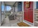 Cozy front porch with comfortable seating, a vibrant red door, and a welcoming 'hello' doormat at 3367 Dove Valley Pl, Castle Rock, CO 80108