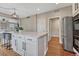 Spacious kitchen island with marble countertops, seating, and hardwood floors extending into adjacent areas at 3367 Dove Valley Pl, Castle Rock, CO 80108