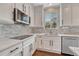 Modern kitchen featuring sleek countertops, stainless steel appliances, and mosaic backsplash at 3367 Dove Valley Pl, Castle Rock, CO 80108