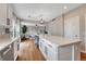 Modern kitchen with island and marble countertop with open access to Gathering room at 3367 Dove Valley Pl, Castle Rock, CO 80108