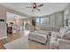 Bright living room with plush seating, large windows, and an open view of the modern kitchen at 3367 Dove Valley Pl, Castle Rock, CO 80108