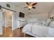 Bright, spacious main bedroom features hardwood floors, ceiling fan and a barn door leading into an ensuite bathroom at 3367 Dove Valley Pl, Castle Rock, CO 80108