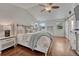 Bright main bedroom with hardwood floors, fan, and natural light at 3367 Dove Valley Pl, Castle Rock, CO 80108