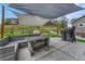 Patio featuring outdoor seating, dining area, grill and sunshade in a grassy backyard at 3367 Dove Valley Pl, Castle Rock, CO 80108