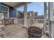 Covered porch with concrete flooring, fire pit, and view of a home exterior featuring brick and wood siding at 3367 Dove Valley Pl, Castle Rock, CO 80108