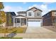 Two-story house with gray siding, white garage door, and a front porch at 6530 13Th St, Frederick, CO 80530