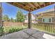 Covered patio with a view of the backyard, complemented by a wooden fence and well-maintained lawn at 6612 S Muscadine Ct, Aurora, CO 80016