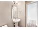 Small bathroom with pedestal sink, modern fixtures, and neutral paint, offering a clean and functional space at 6612 S Muscadine Ct, Aurora, CO 80016