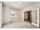 Bright bedroom featuring a large window and french doors at 6612 S Muscadine Ct, Aurora, CO 80016