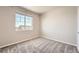 Bright bedroom with a large window, neutral walls, and plush carpeting, perfect for relaxation at 6612 S Muscadine Ct, Aurora, CO 80016