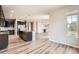 Open-concept kitchen featuring stainless appliances and hardwood floors at 6612 S Muscadine Ct, Aurora, CO 80016