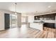 Open kitchen and living area featuring modern cabinetry and stainless appliances at 6612 S Muscadine Ct, Aurora, CO 80016