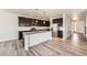 Spacious kitchen featuring modern cabinetry, stainless appliances, and a large center island at 6612 S Muscadine Ct, Aurora, CO 80016