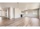 Bright living room featuring modern flooring, a fireplace and an open floor plan at 6612 S Muscadine Ct, Aurora, CO 80016