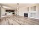 Bright living room featuring a fireplace, neutral paint, and hardwood floors, providing a cozy gathering area at 6612 S Muscadine Ct, Aurora, CO 80016