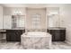 Luxurious main bathroom featuring dual vanities, a soaking tub, and stylish tile work, creating a spa-like retreat at 6612 S Muscadine Ct, Aurora, CO 80016