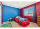 Fun bedroom featuring a race car bed, colorful walls, and playful decor at 19823 E 58Th Ave, Aurora, CO 80019