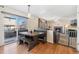 Bright dining area featuring a rustic wooden table and bench seating next to a sliding door at 19823 E 58Th Ave, Aurora, CO 80019