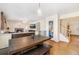 Bright dining area featuring rustic table, bench seating, and open view to Gathering room at 19823 E 58Th Ave, Aurora, CO 80019