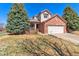 Charming brick two-story home with mature trees and attached two-car garage at 19823 E 58Th Ave, Aurora, CO 80019