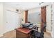Bright home office featuring a wood desk, ergonomic chair, and natural light from the window at 19823 E 58Th Ave, Aurora, CO 80019