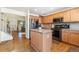 Open kitchen layout with stainless appliances, tile backsplash, and adjacent dining area at 19823 E 58Th Ave, Aurora, CO 80019