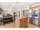 Bright kitchen area with stainless steel refrigerator and wooden island with countertops at 19823 E 58Th Ave, Aurora, CO 80019