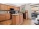 Well-equipped kitchen with central island, stainless steel appliances, and tile backsplash at 19823 E 58Th Ave, Aurora, CO 80019