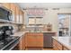 Close view of kitchen features including stainless appliances and neutral backsplash at 19823 E 58Th Ave, Aurora, CO 80019