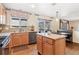 Features a kitchen with light wood cabinets, stainless appliances, and a window at 19823 E 58Th Ave, Aurora, CO 80019
