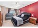 Main bedroom features a tufted bed, crib, and is adorned with dark-colored curtains and accents at 19823 E 58Th Ave, Aurora, CO 80019