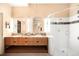 Bright bathroom featuring double vanity sinks, and walk-in shower with glass door at 1610 Little Raven St # 502, Denver, CO 80202