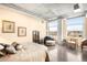 Spacious bedroom with a concrete ceiling, cityscape views, and comfortable seating area at 1610 Little Raven St # 502, Denver, CO 80202
