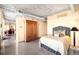 Bedroom featuring concrete ceilings, open floorplan, living space and comfortable bed at 1610 Little Raven St # 502, Denver, CO 80202