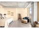 Bright bedroom featuring concrete ceilings, modern furnishings and a view from the large window at 1610 Little Raven St # 502, Denver, CO 80202