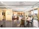 Open concept living area featuring dining table, kitchen, breakfast bar and a wall of windows at 1610 Little Raven St # 502, Denver, CO 80202