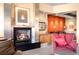 Cozy fireplace nestled between comfortable armchairs, adjacent to a colorful accent wall at 1610 Little Raven St # 502, Denver, CO 80202