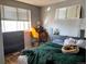 Bedroom with two windows, writing desk, and dog bed with dog in it at 3190 S Joplin Ct, Aurora, CO 80013