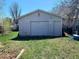 Backyard featuring a detached single car garage with white siding and a new roof at 3190 S Joplin Ct, Aurora, CO 80013