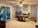 Living room with ceiling fan, white fireplace and hearth, tile flooring and access to backyard at 3190 S Joplin Ct, Aurora, CO 80013