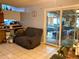 Living room with gray walls, tile flooring and door to unfinished space at 3190 S Joplin Ct, Aurora, CO 80013