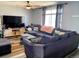 Inviting living room featuring a sectional sofa, modern wood flooring, and soft natural lighting at 3190 S Joplin Ct, Aurora, CO 80013