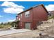 Beautiful two-story home with wood exterior, attached garage and concrete driveway at 826 Meadow Ln, Palmer Lake, CO 80133